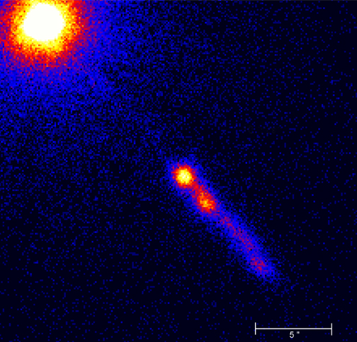 Quasar 3C273, a bright round object with a jet emerging from it.