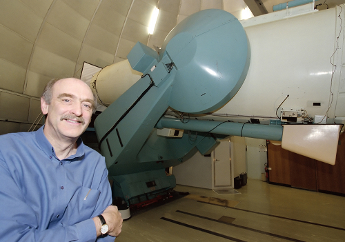 Fred Watson in front of a large telescope