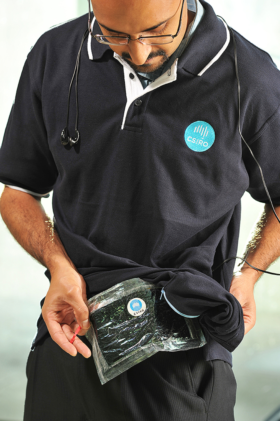 CSIRO researcher Dr Anand Bhatt models a shirt with a pocket incorporating the CSIRO flexible battery, which can be used to power small consumer electronic devices
