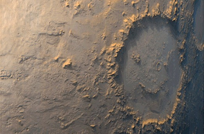 All sorts of natural features can look like a face, including this large Martian crater. Image: NASA