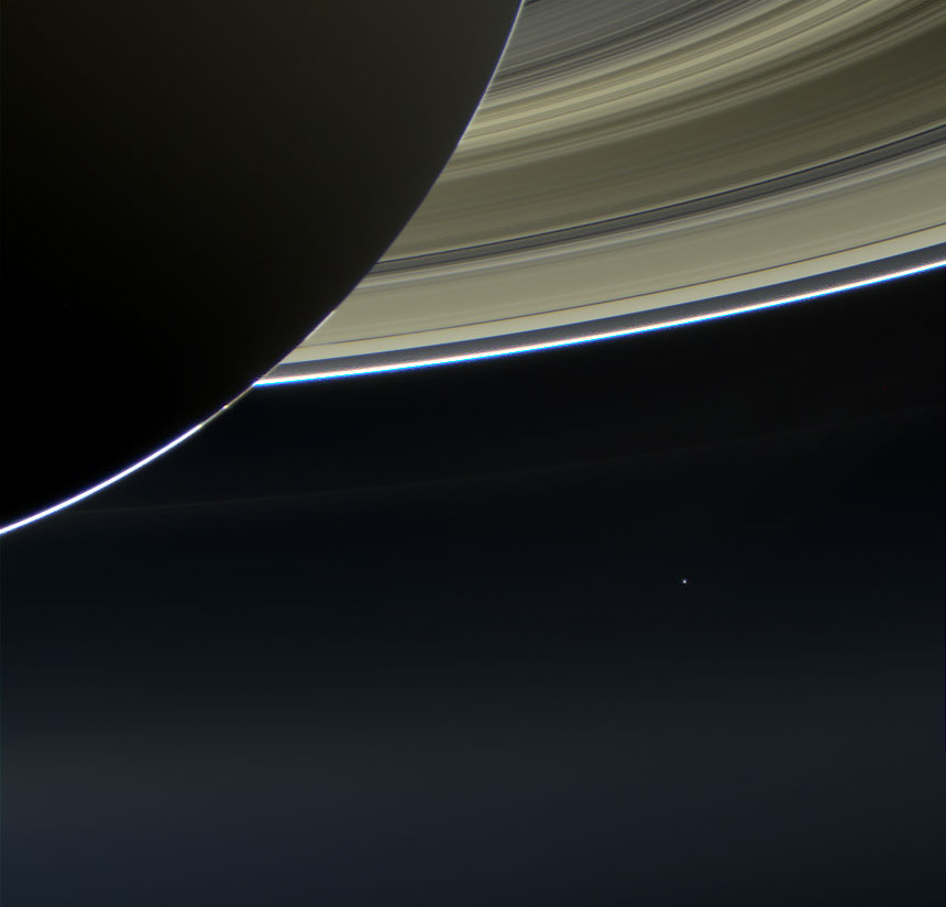 The pale blue dot of Earth is seen just below the rings of Saturn. Raw images: NASA
