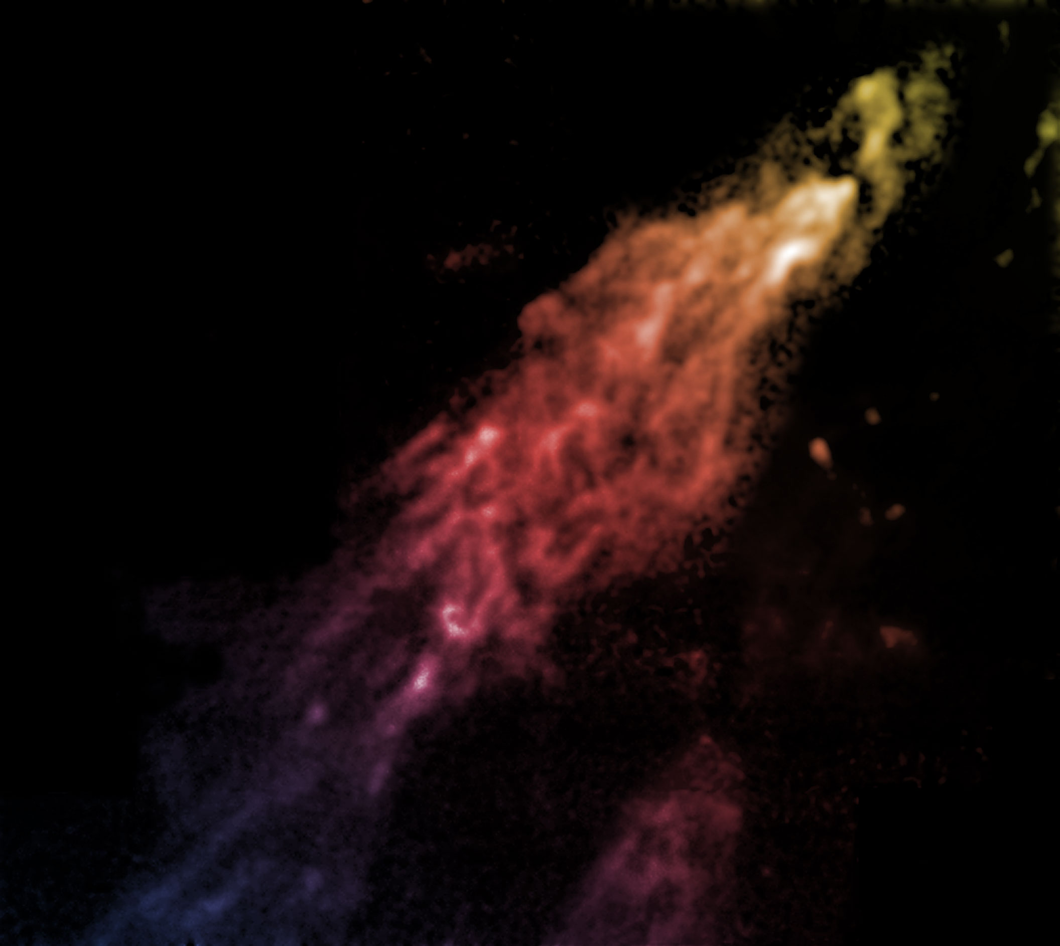 A comet-shaped cloud of gas, coloured from yellow at one end through to orange, pink then purple.