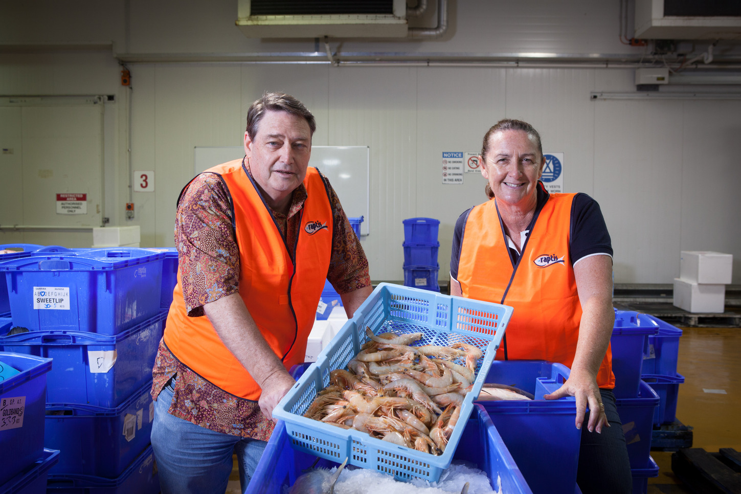 Marine scientists Rik Buckworth and Tonya van der Velde inspect prawns from the Northern Prawn Fishery at the Raptis Fish Markets in Brisbane