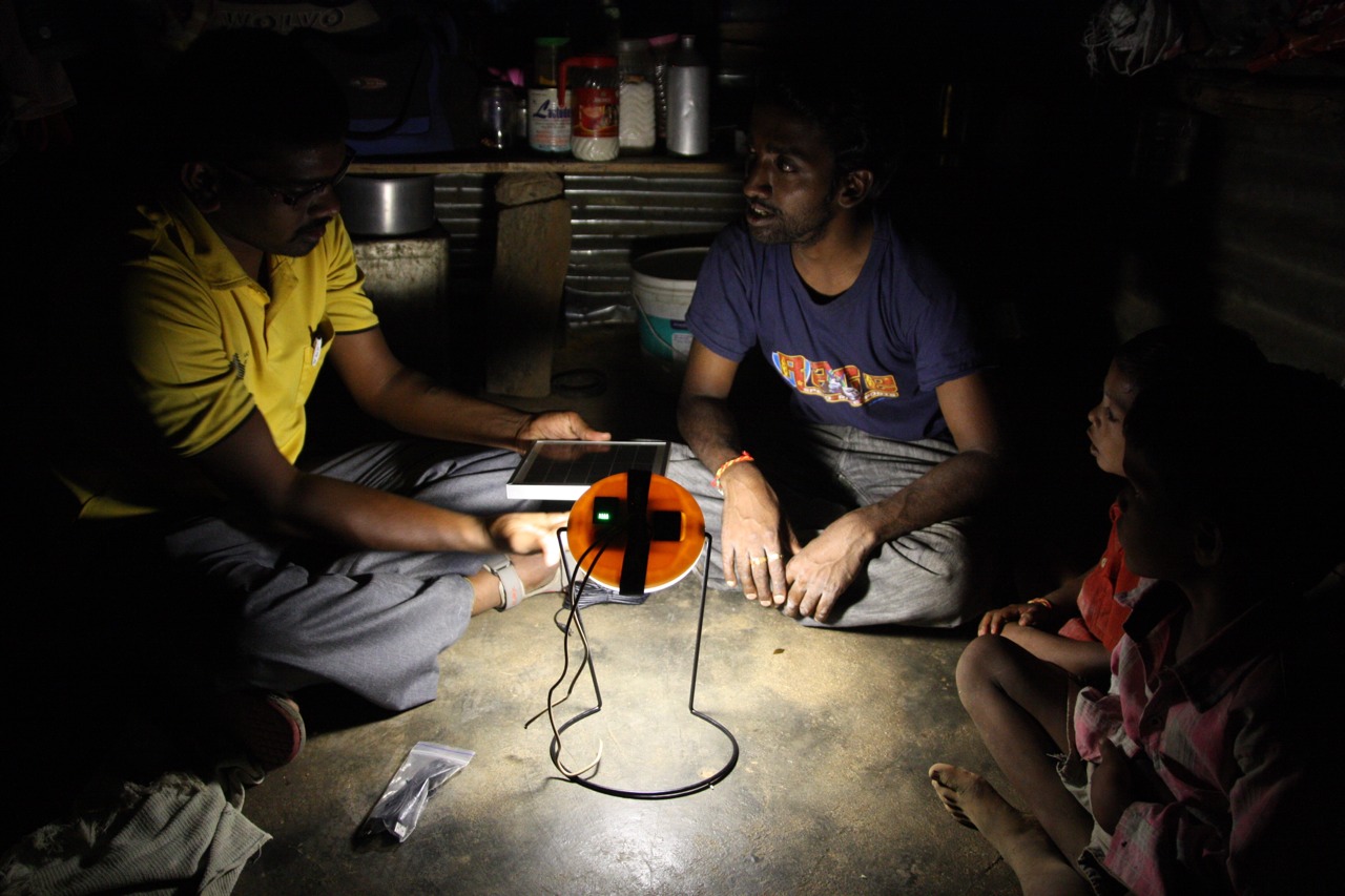 Helping a family get a solar-powered light for their home for the very first time.