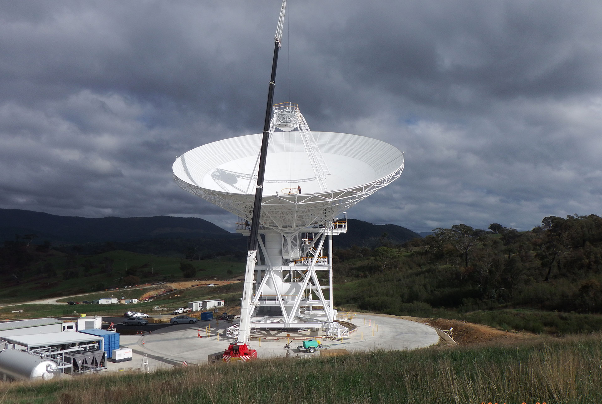 A worker in the centre of the DSS35 dish is dwarfed by the scale of the 34 metre wide dish.