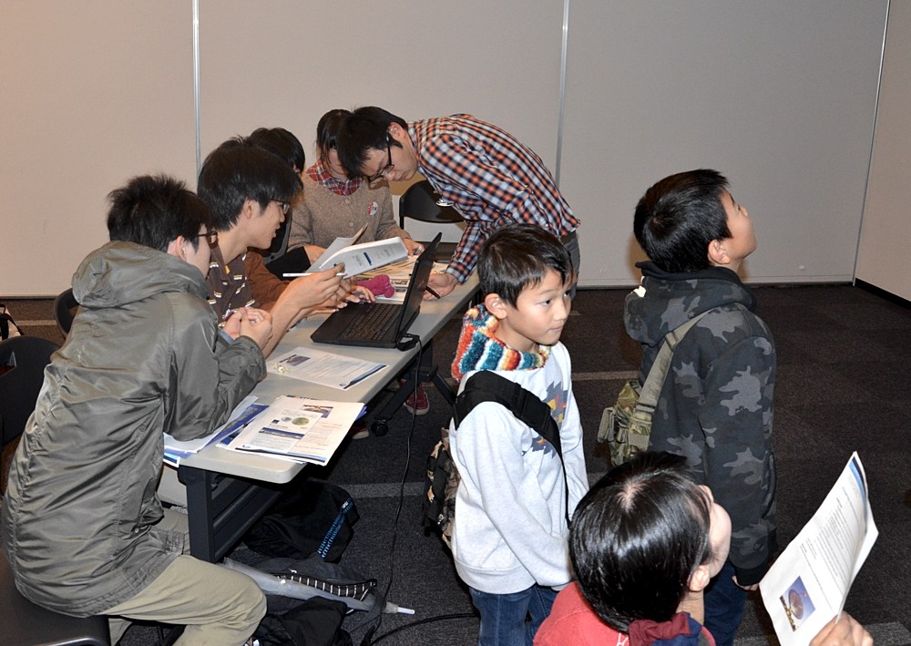 Students analysing their data whilst some young members of the public view the telescope in action at Sendai.