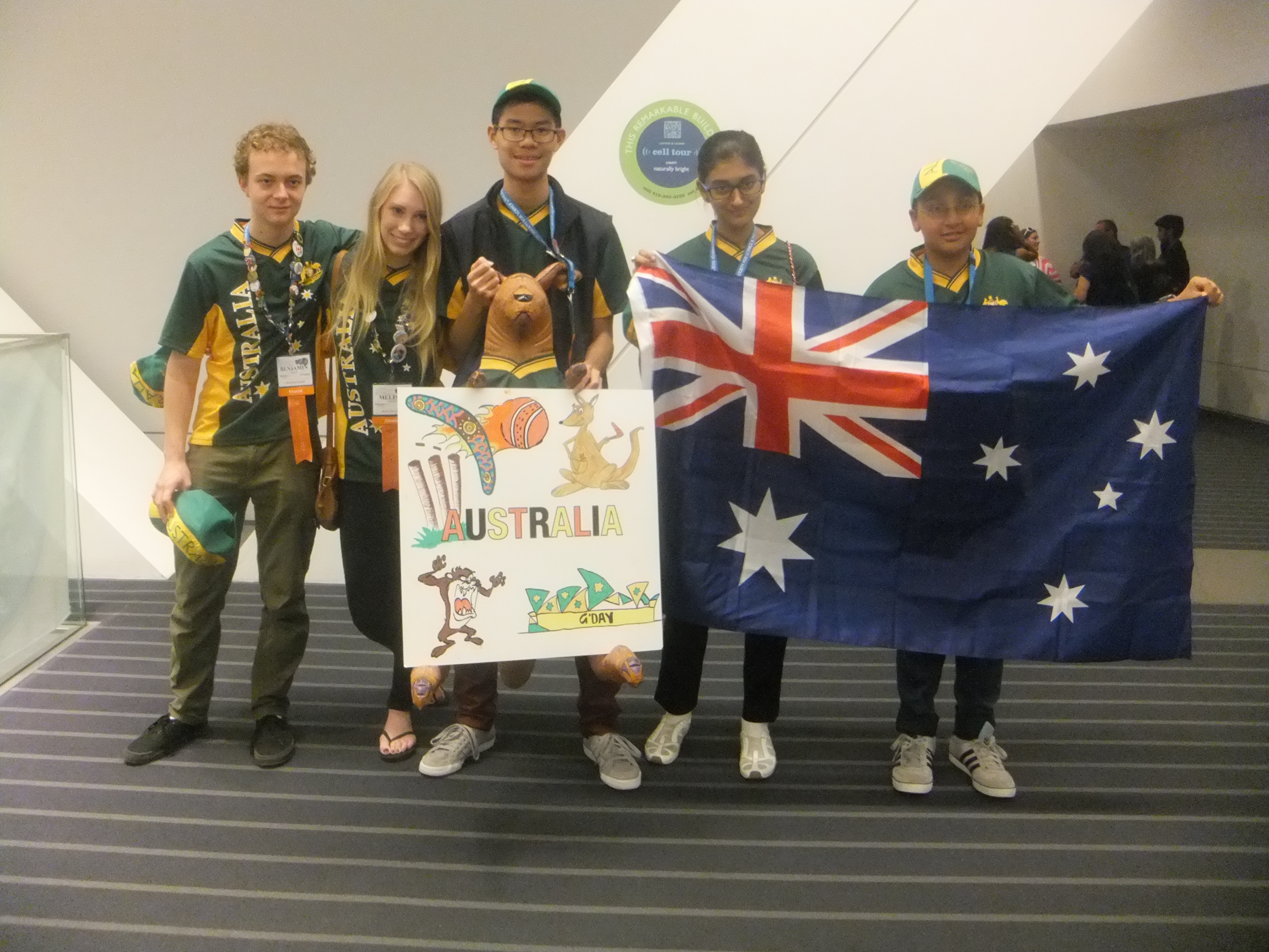 Five winners holding an inflatable kangaroo mascot.