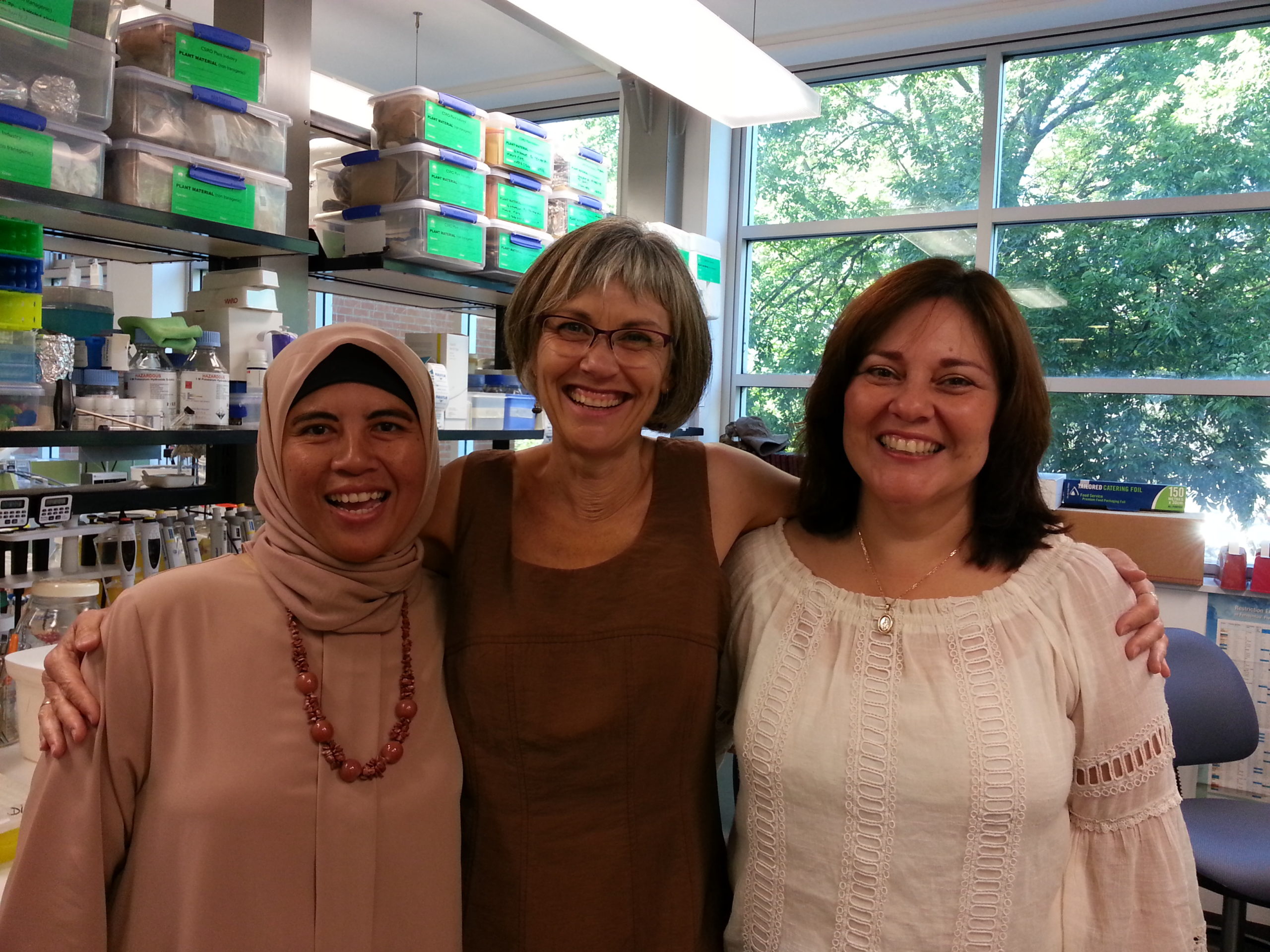 A smiling team of Dina, Judith and Lissette at their lab in Canberra