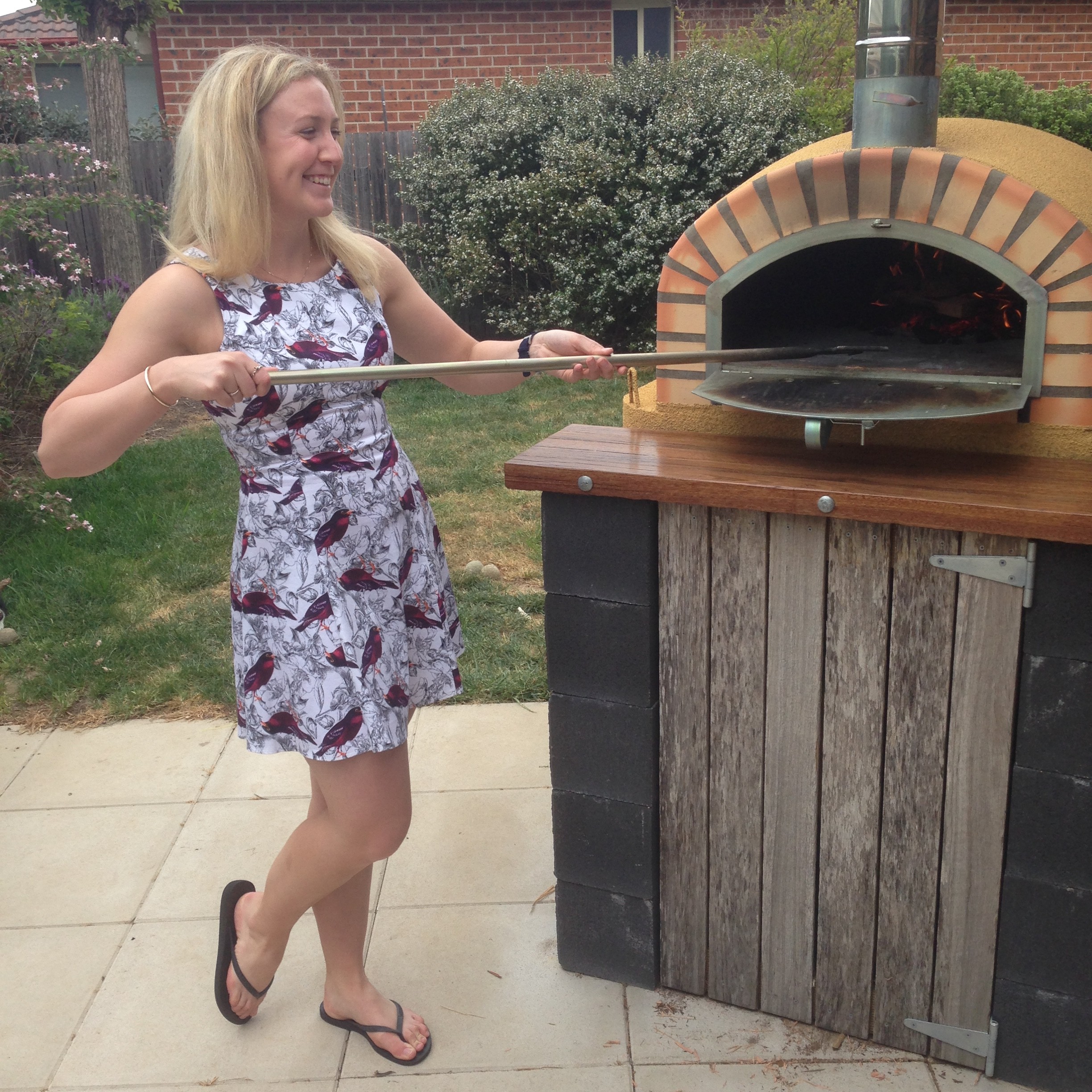 Hannah Scott working her skills at a wood-fired pizza oven