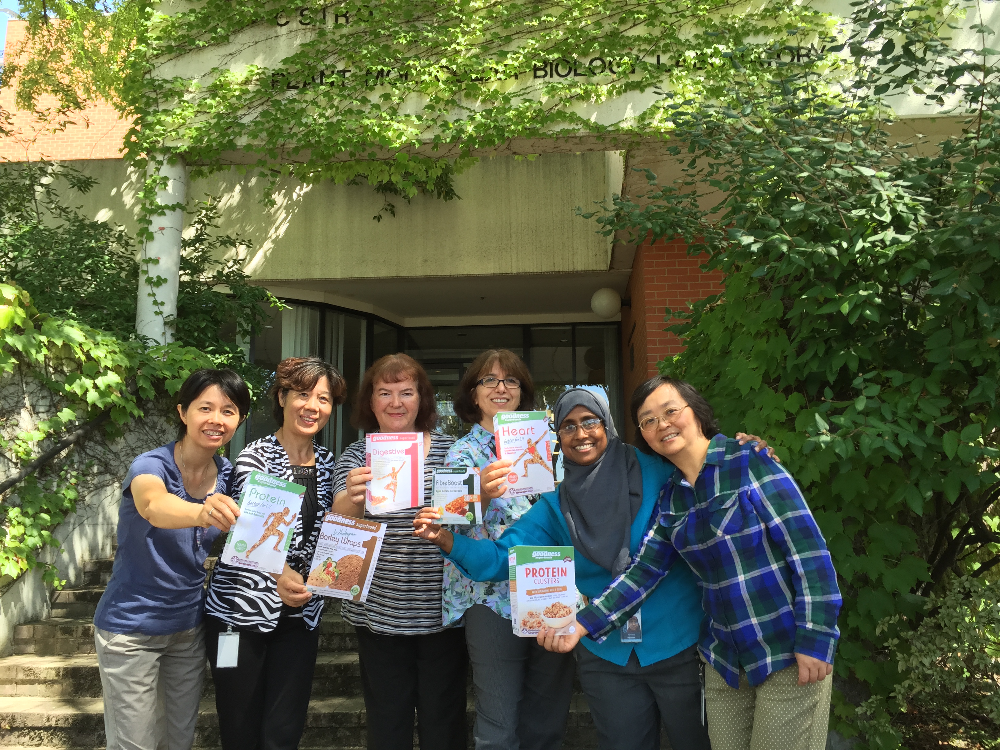 Women in Cereal Starches Team holding boxes of cereal- Min, Suzhi, Chris, Behjat, Regina, Hong