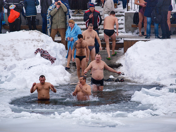 Men walking into ice bath.