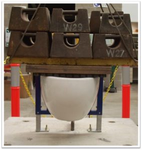 weights loaded onto a toilet bowl to test it's load bearing