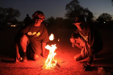 Indigenous students by a camp fire during a Science Pathways trip to the edge of the Gibson Desert