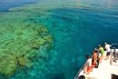 Tourists looking at the Great Barrier Reef from a boat