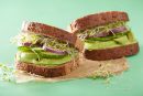 avocado and salad sandwich on a piece of brown paper