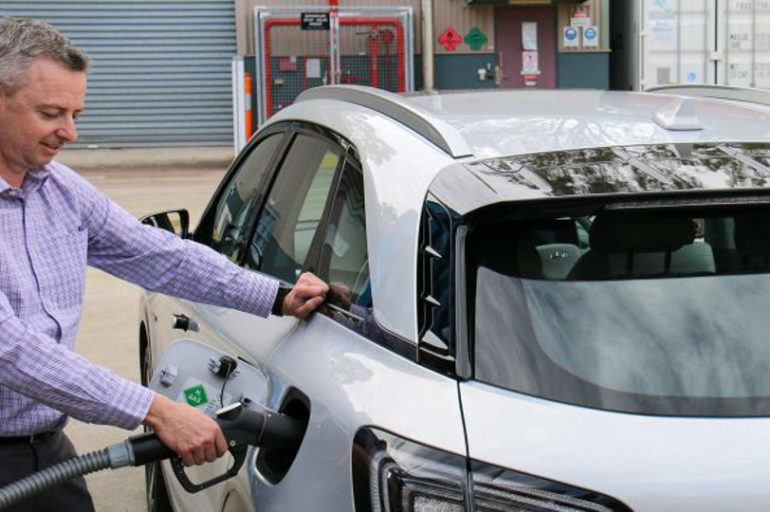 A man refuelling a hydrogen car using hydrogen from ammonia