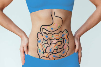 close up on lady's stomach with the gut system drawn on