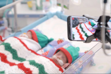 Two premature babies in crib in hosptial. Camera setup filming them