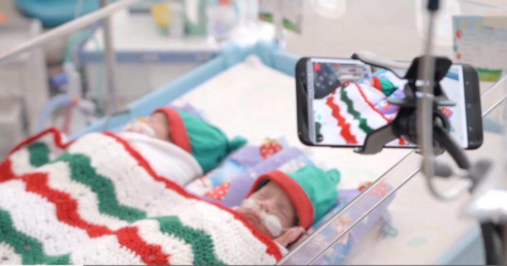 Two premature babies in crib in hosptial. Camera setup filming them 