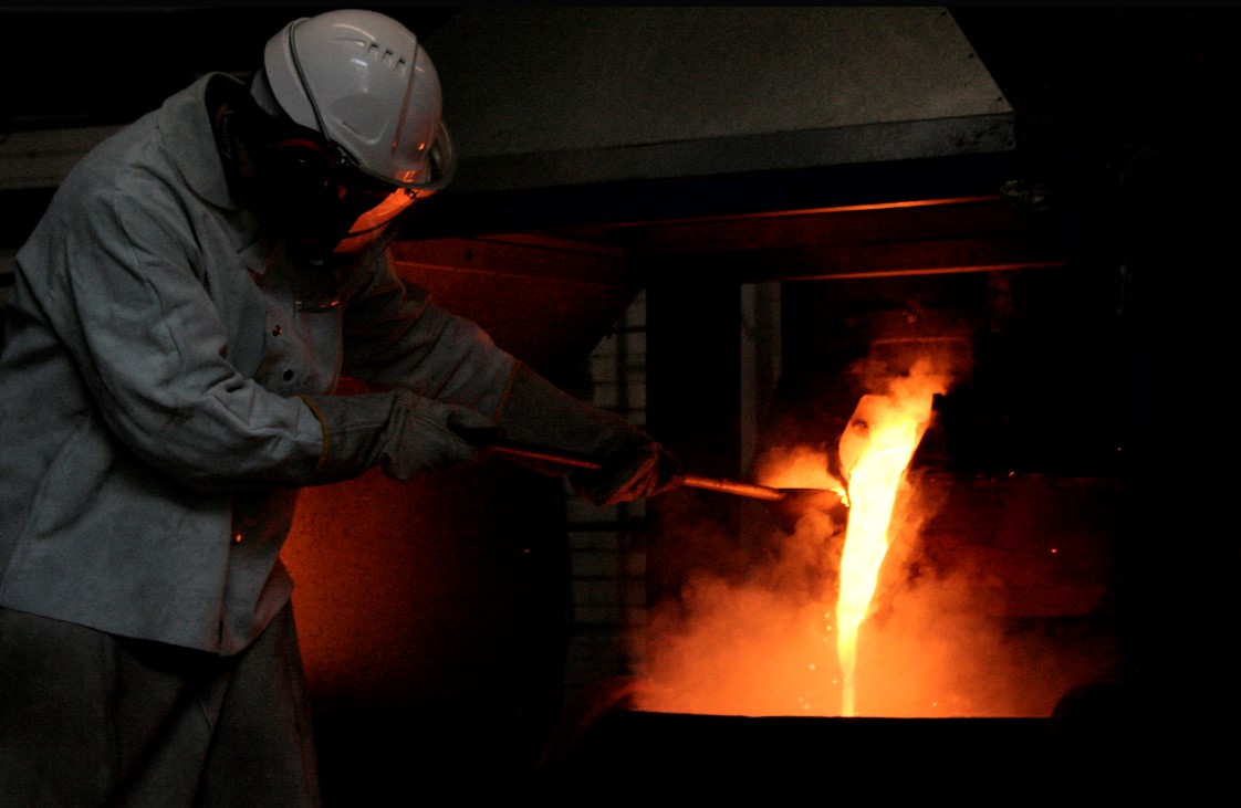 Person smelting metal in a kiln