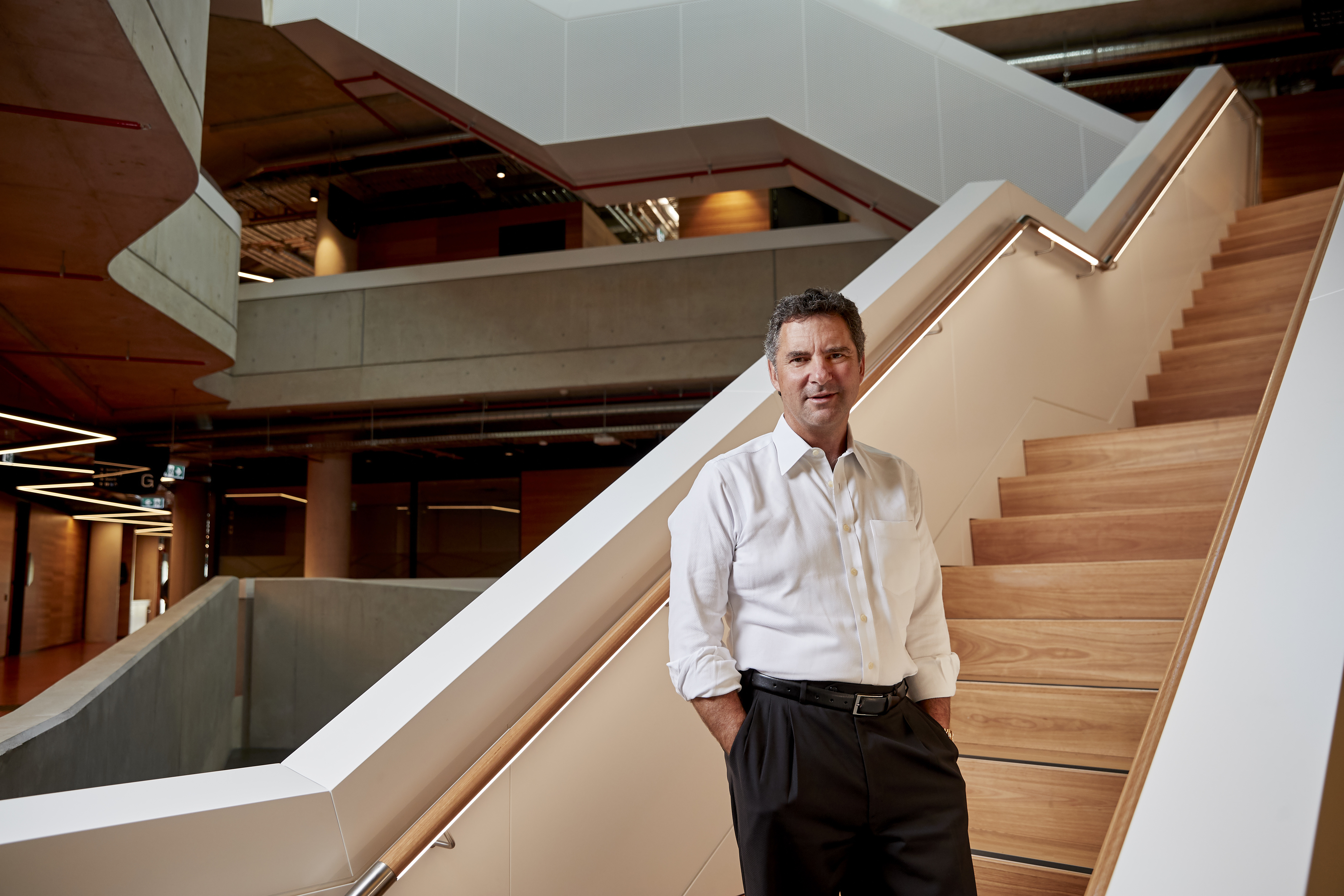 CSIRO Chief Executive, Larry Marshall standing in front of a staircase