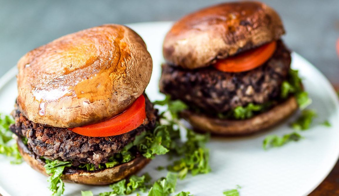 vegan burgers with mushroom 'buns'on a plate