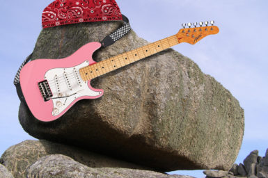 Photo of a rock playing rock songs with a bandana and electric guitar photoshopped on