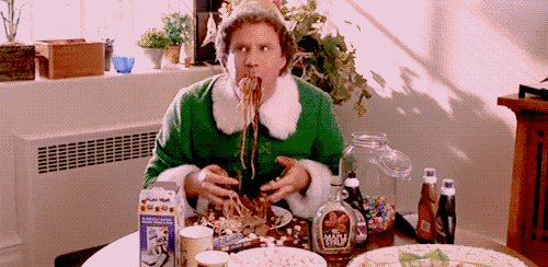 Elf movie scene where elf is eating spaghetti with toppings