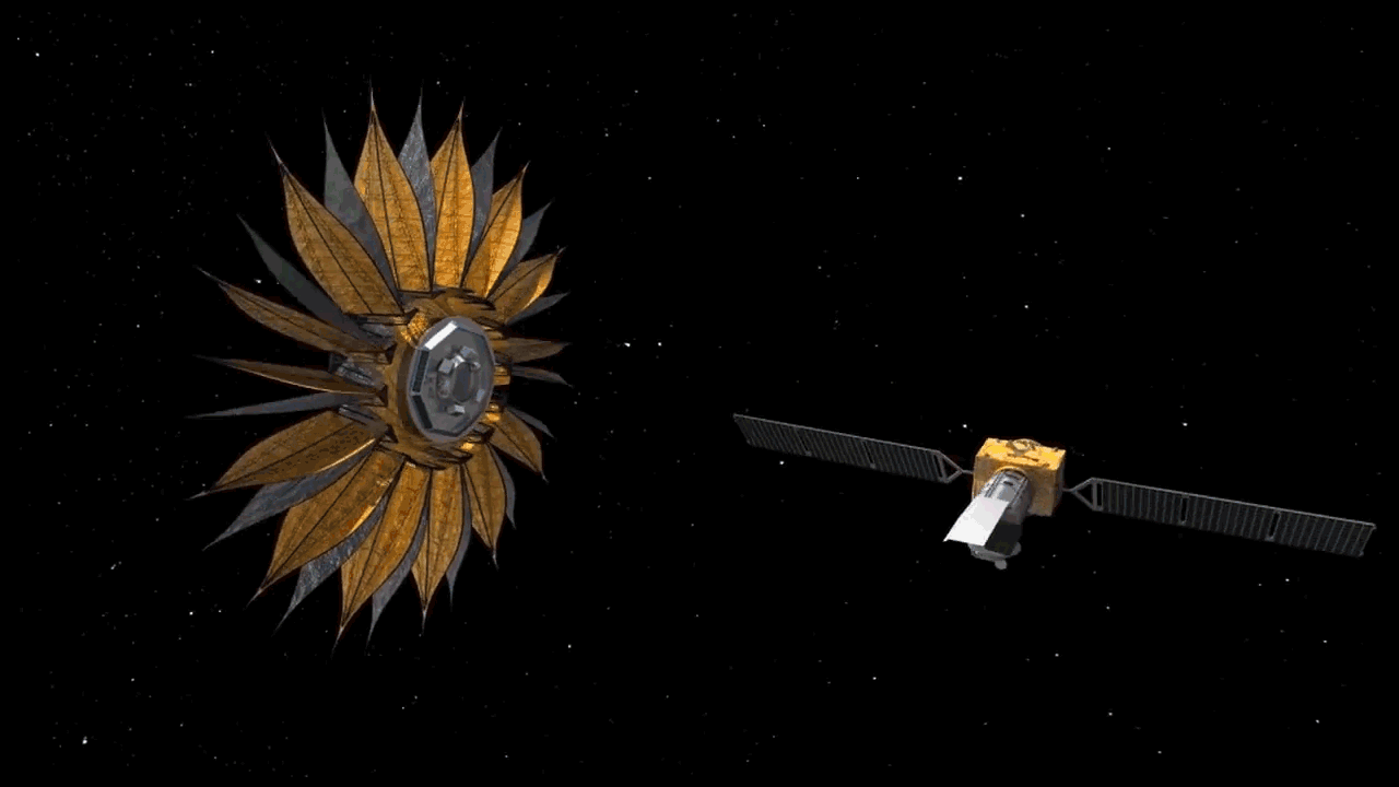 an enormous sunflower looking object contracts to an umbrella like structure, in space, with a satellite orbiting in front of it. 