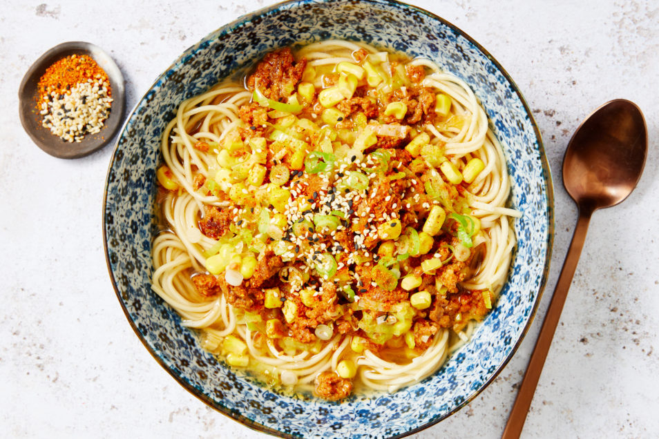 Plant-based Mince Chilli Raman with Leek and Corn served with spaghetti in blue and white bowl
