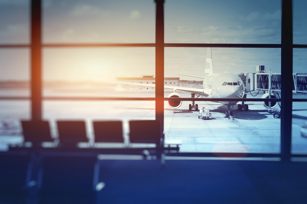 aeroplane waiting for departure in airport terminal, blurred horizontal background