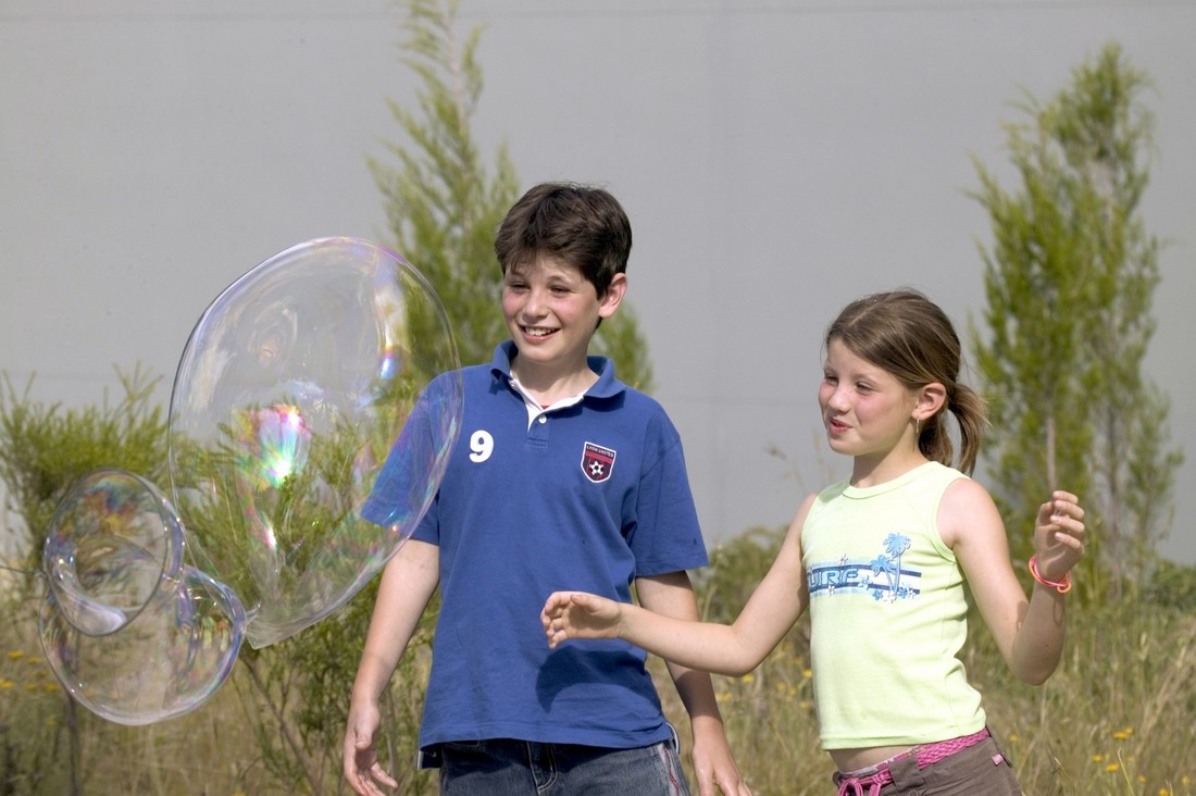 Exterior view of children playing with soap bubbles