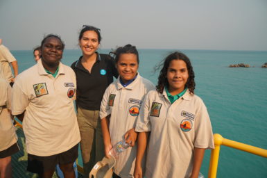 Marlee Hutton standing on a jetty with Broome Senior High School Bushrangers on the Ey