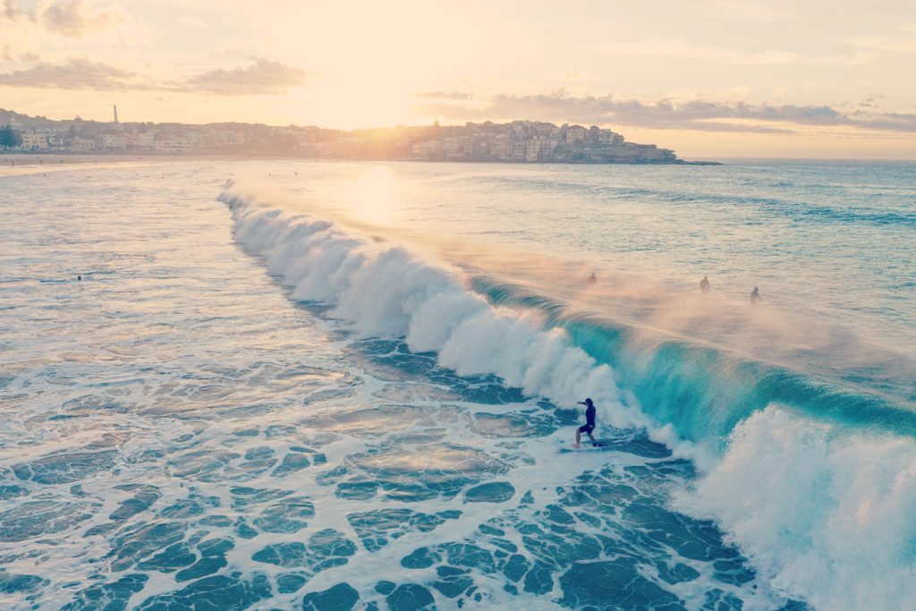 Image of a person surfing on a wave in the ocean