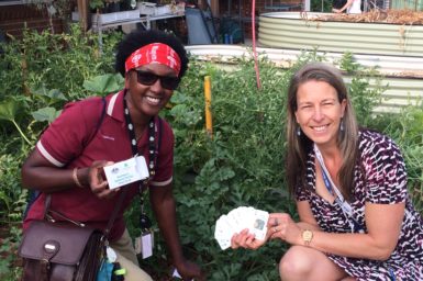Carol and Kate holding a pack of the plant pest playing cards that they designed with the students. Part of their teacher and entomologist classroom collaboration