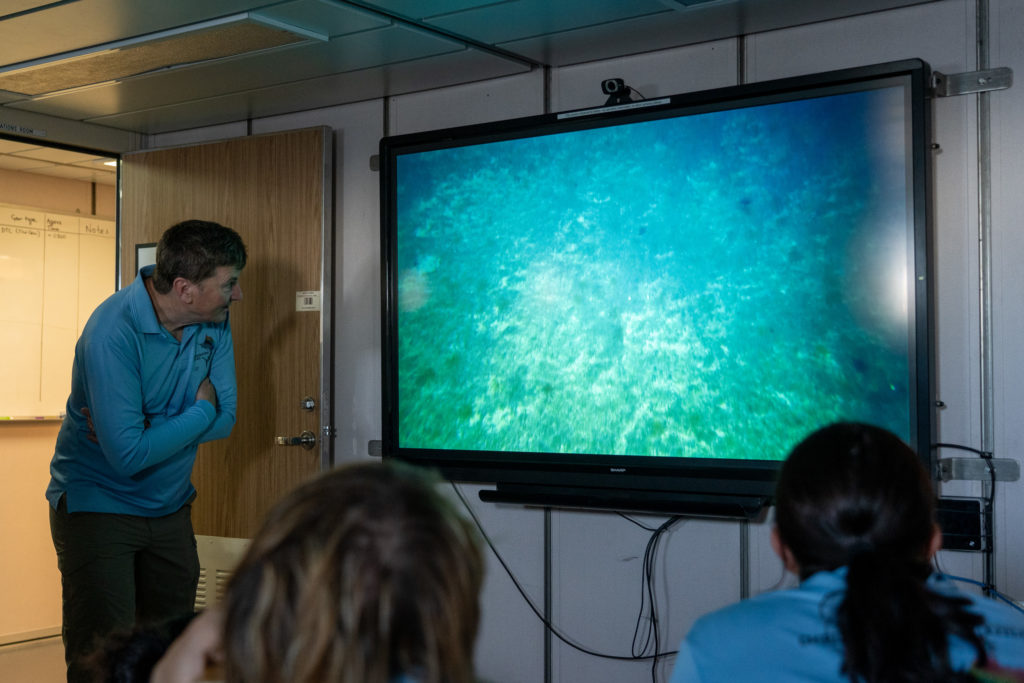 People watching a screen showing underwater