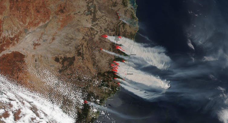Satellite image of New South Wales coast with red dots highlighting fires and the smoke from them.