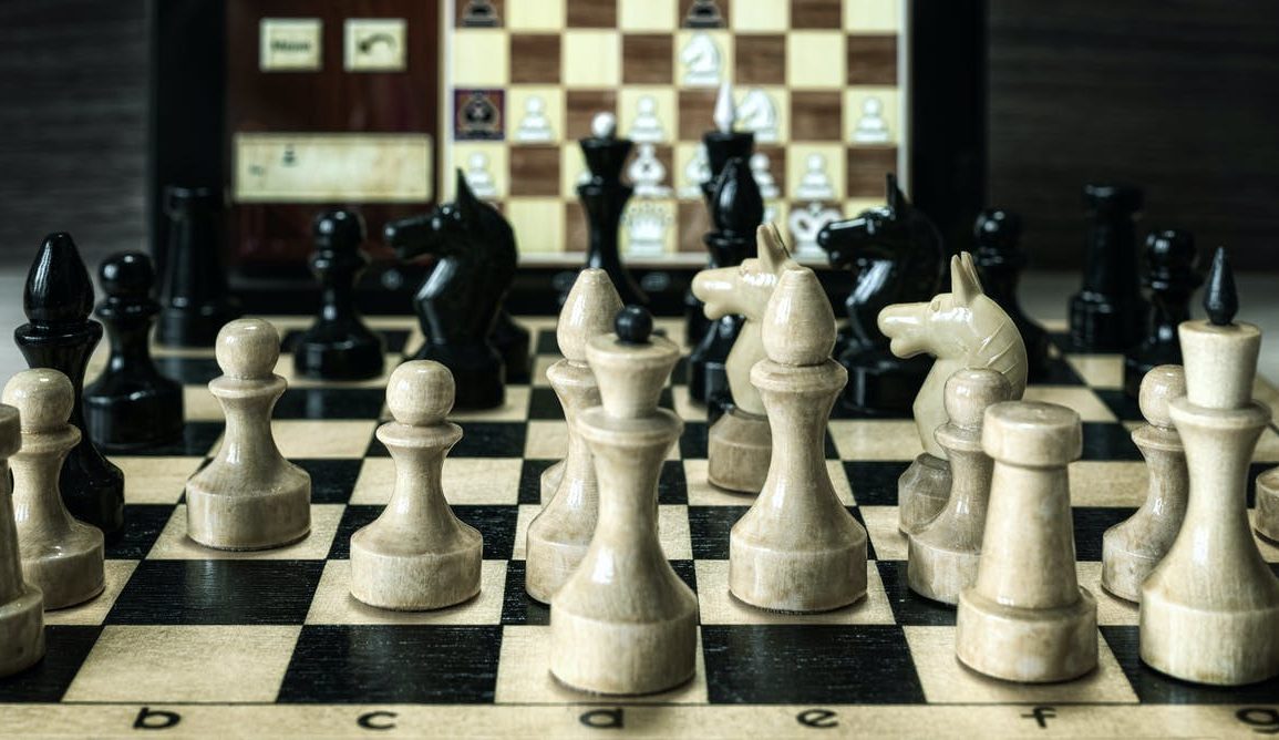 Black and white chess pieces on a chess board.