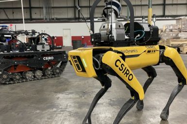Yellow four legged robot in a factory