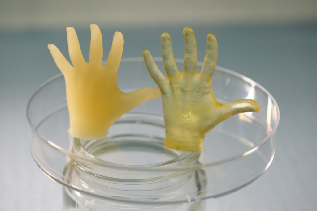 A photo of two small hands that were 3D printed with silicone.