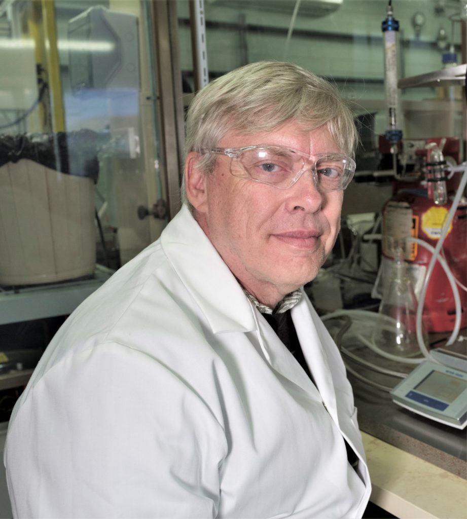 Headshot of CSIRO polymer chemist, Dr Graeme Moad, in laboratory. 