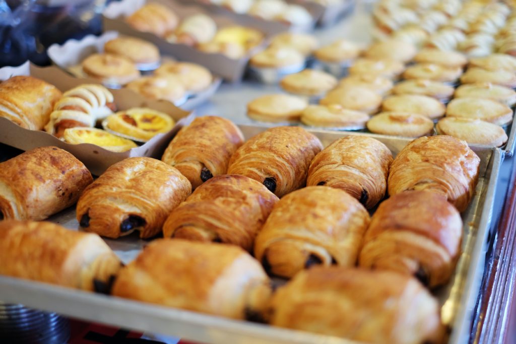 Trick your brain into eating healthy by swapping baked goods (like this tray of croissants and tarts) for a mandarin.