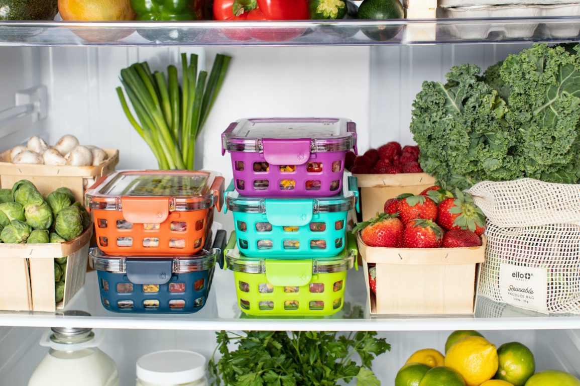 A neatly organised fridge with colourful storage containers