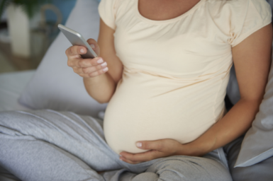 Pregnant women holding her phone