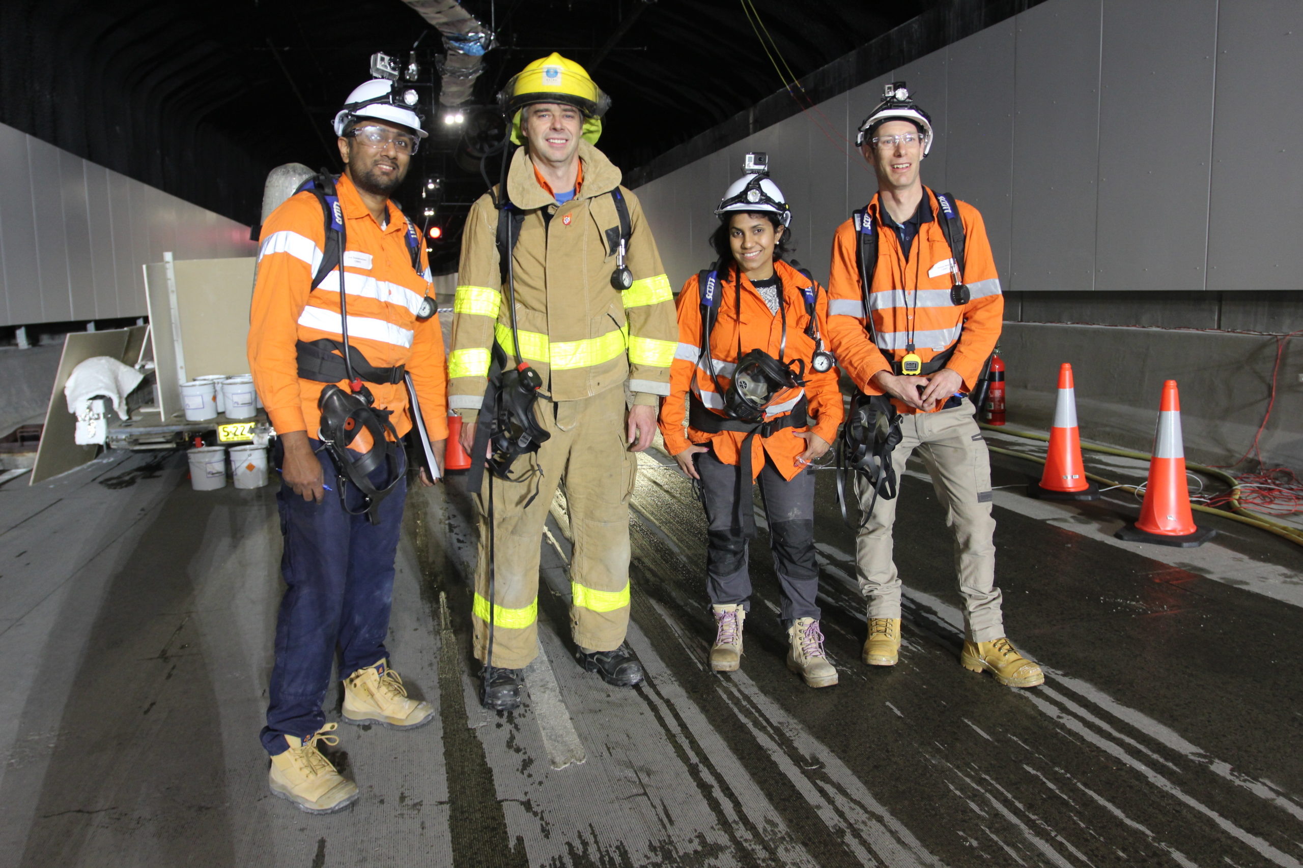 Tunnel safety. Image of a team of four testing safety equipment in a tunnel.