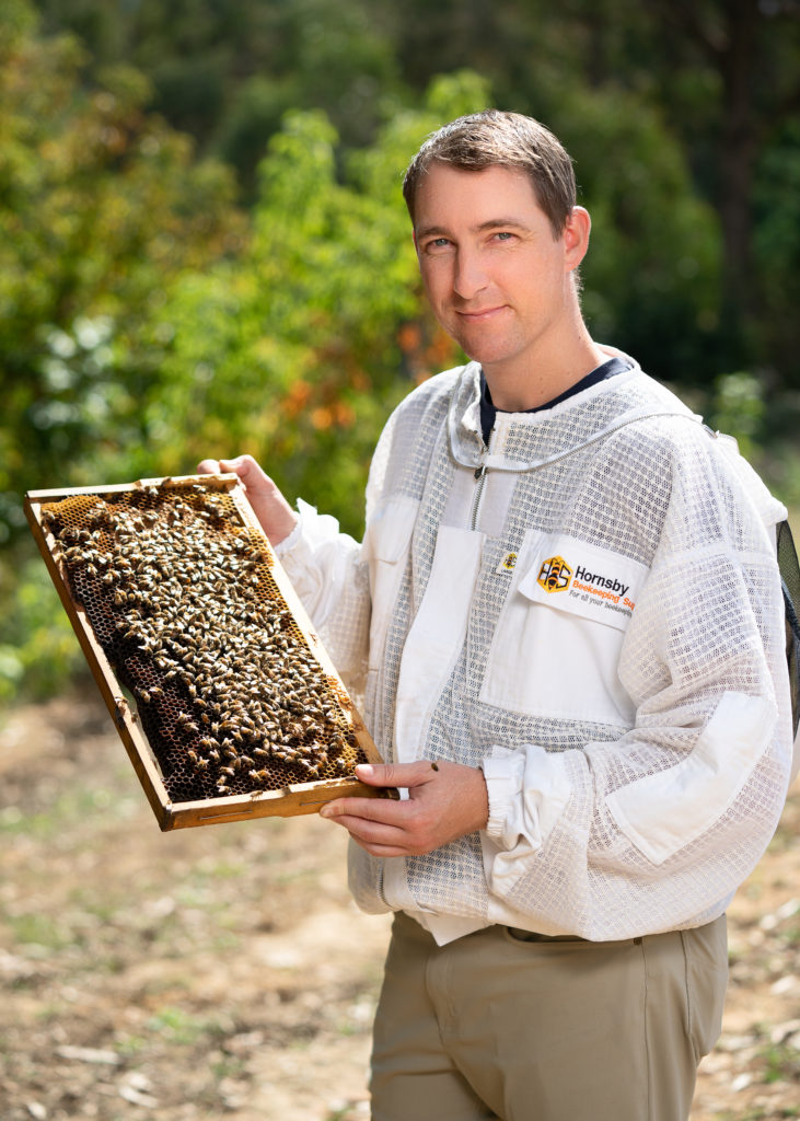 Dr John Roberts holding a tray of bees. 