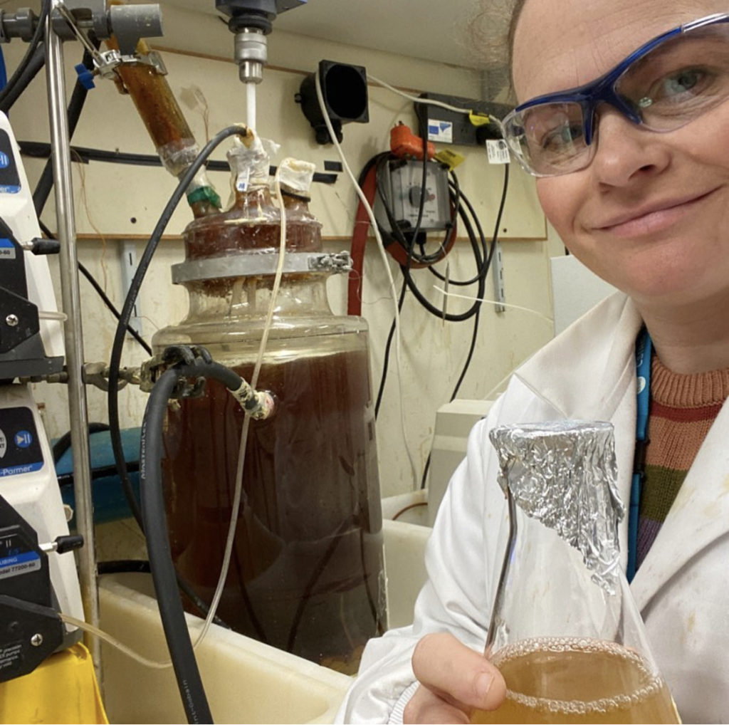 Naomi Boxall in the lab with a beaker 