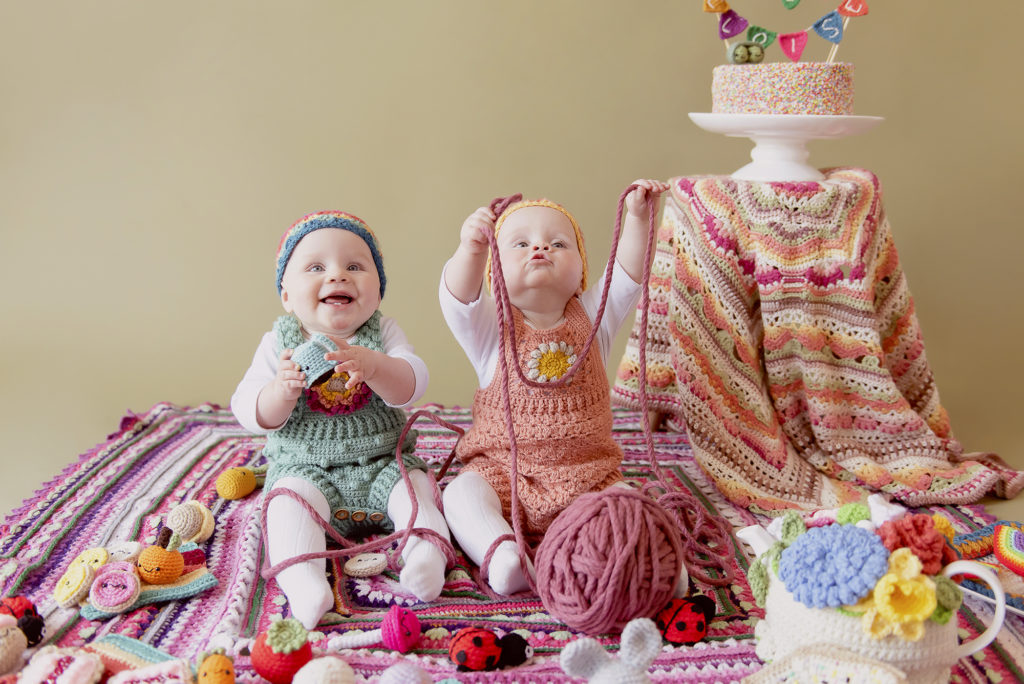 Naomi Boxall's twin girls sitting in and around her crochet.