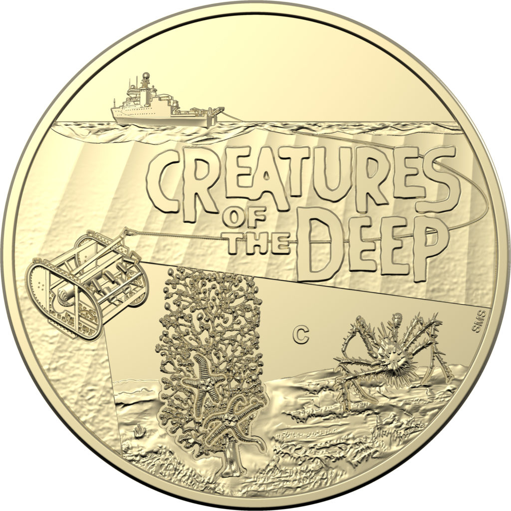 A gold coin with the text "creatures of the deep". A crab, coral and deep-towed camera are seen under the water's surface. A small ship floats on top in the distance.