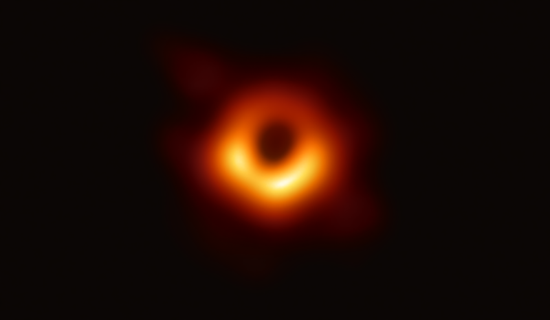 A blurry orange ring of light against a dark background